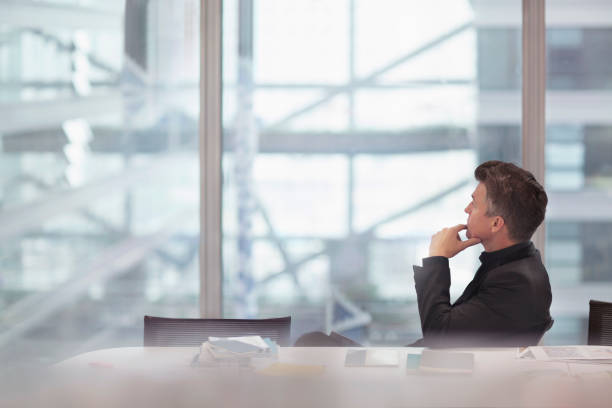 istock Businessman sitting at conference table brainstorming ideas 1148138363