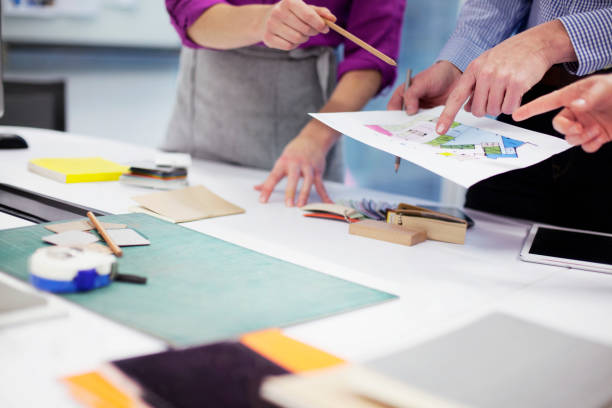 istock Hands of designers pointing to layout at table 1148139129