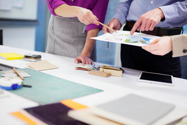 istock Hands of designers pointing to layout at table 1148139137
