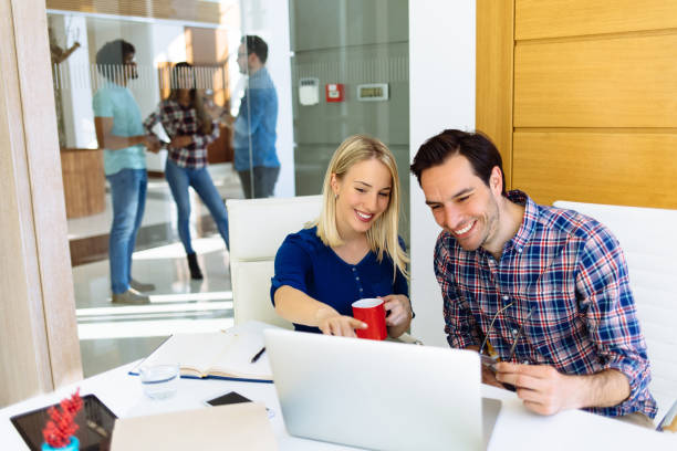 istock Business couple working together on project at modern startup office 1148140890