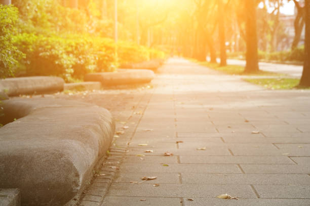 Surface of pedestrian walking path from low angle with perspective stretching into distance, in background resting on front. Outdoor public spaces in an urban environment
