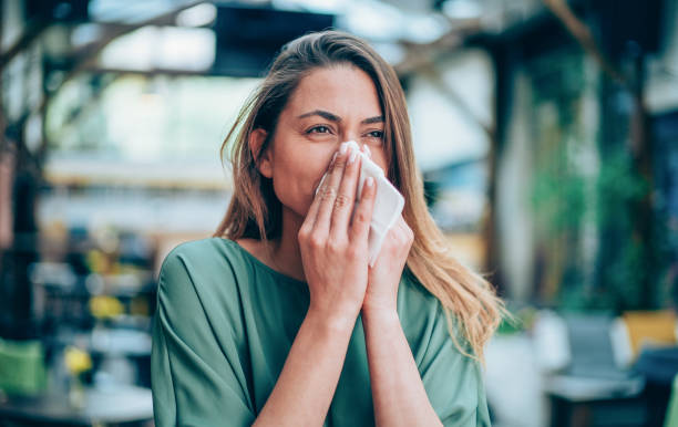 Allergy Shot of a young woman blowing her nose hayfever stock pictures, royalty-free photos & images