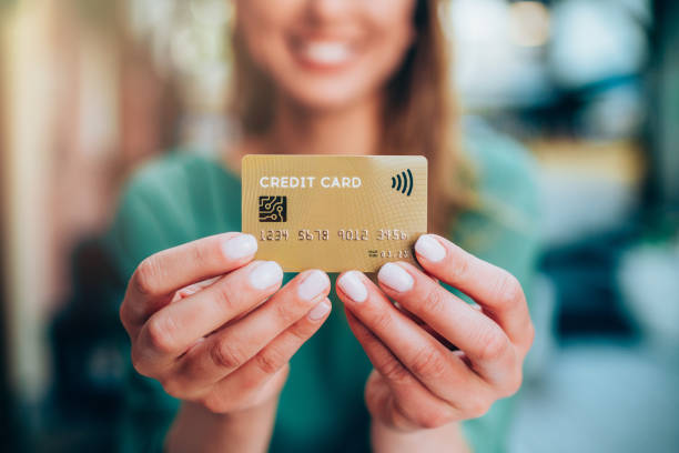 istock Woman holding a credit card 1148143441