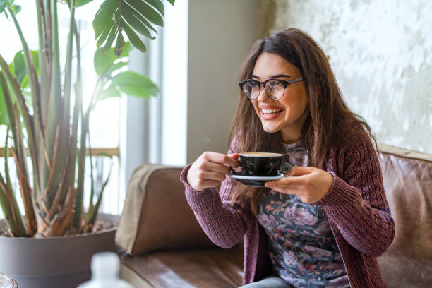 istock Woman relaxing on couch with coffee 1148144505