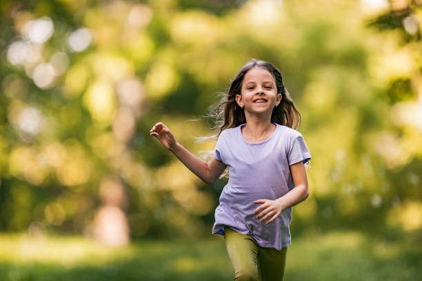 istock Happy little girl having fun while running in nature. 1148145436