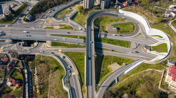istock Aerial photography. Exit from the underground tunnel. Bypass road. Transport ring. Multi-level road junction. Alternate of Kurortny Avenue, Sochi. Top view on a Sunny day. 1148145660