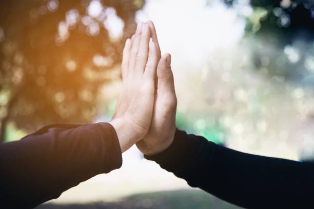 istock Man touching / holding hand together for success 1148145726