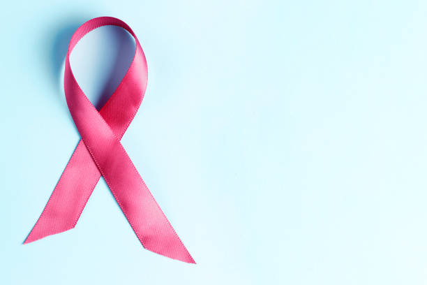 istock pink ribbon on light blue background, breast cancer concept 1148145772