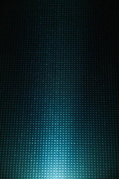A ray of light on a dark background in a cage