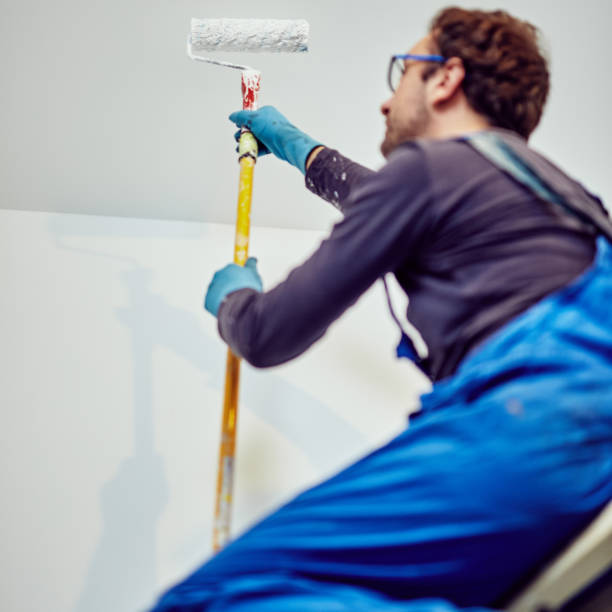 istock Worker painting walls inside the house - renovation fixes. 1148148287
