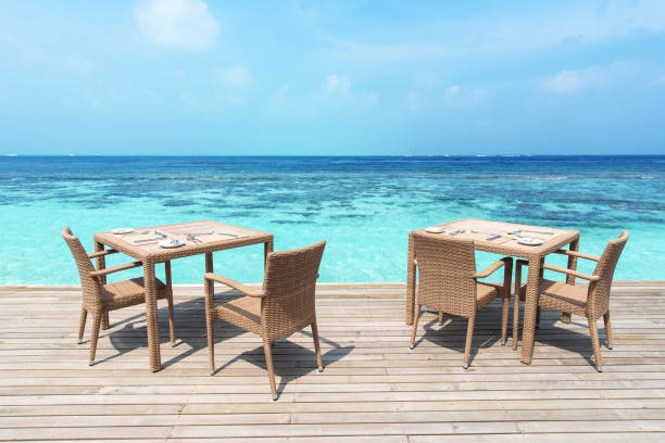 istock Tables and chairs at seaside restaurant with beautiful view 1148148359