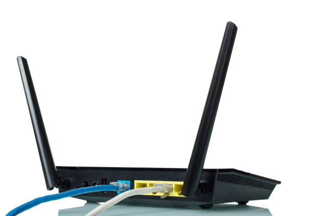 istock Black router with an attached blue and grey wires isolated on white 1148148407