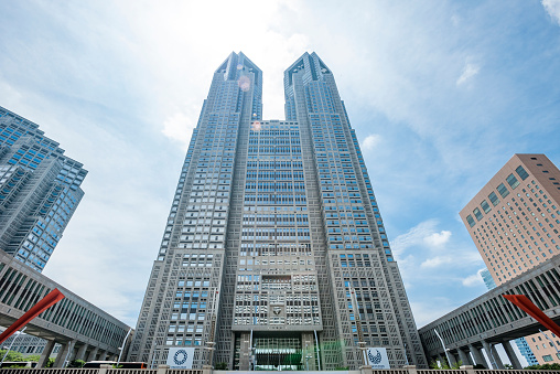 The Tokyo Metropolitan Government Building in Shinjuku is often visited by tourists for its free observation decks which provide good panoramic views of Tokyo and beyond. The 243 meter tall building has two towers, and each houses an observatory at a height of 202 meters. It had been the tallest building in Tokyo until it was overtaken by the Midtown Tower in 2007.