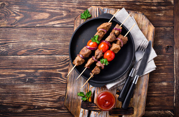 istock Grilled shish kebab skewers  with tomatoes 1148150224