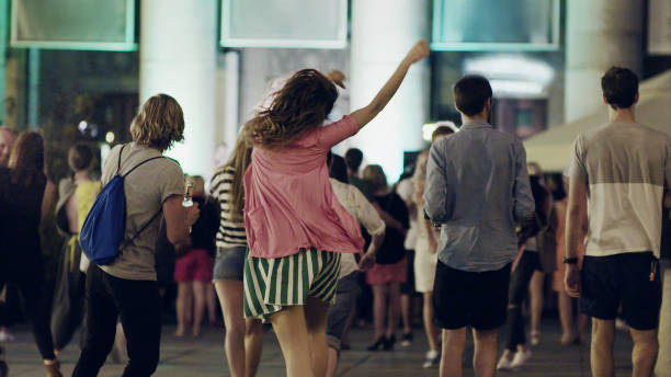 istock Summer night in the city. Crowd cheering and dancing 1148151366