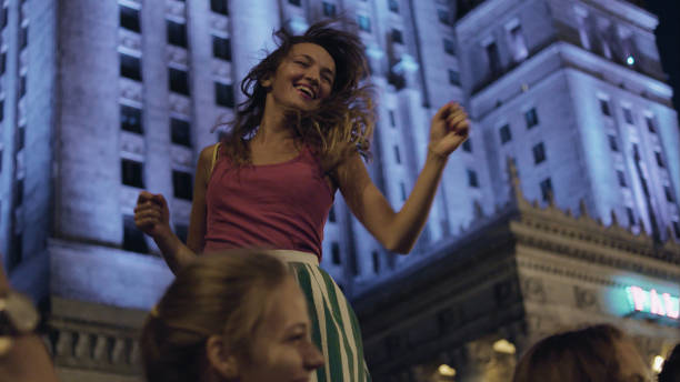 Summer night in the city. Crowd cheering and dancing