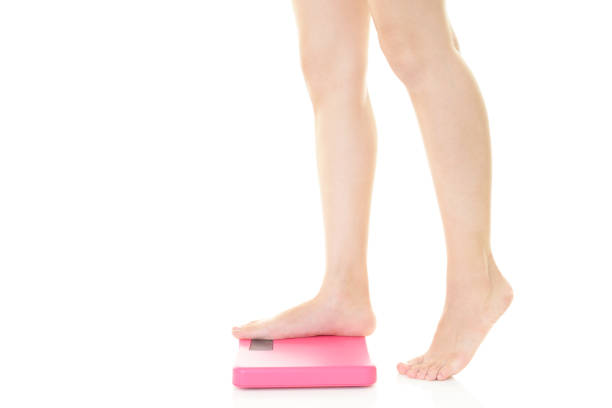 istock Young woman measuring weight 1148152294