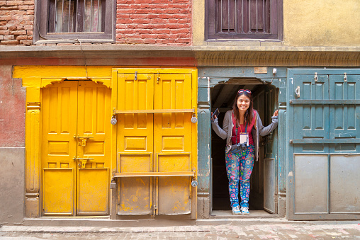 A women tourist enjoying with beautiful vintage window and door background at Kathmandu, Nepal