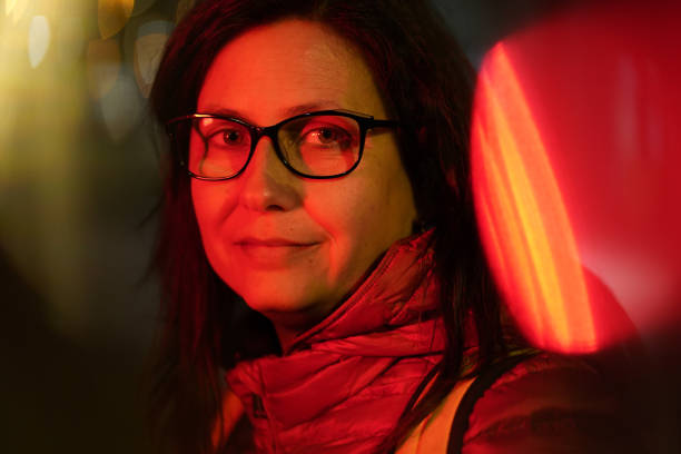 Middle aged woman at the street at night stock photo