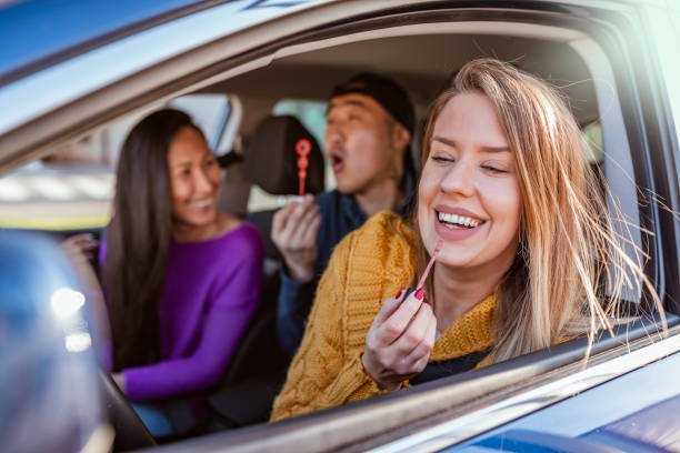 istock Woman applying lipstick in a car 1148154626