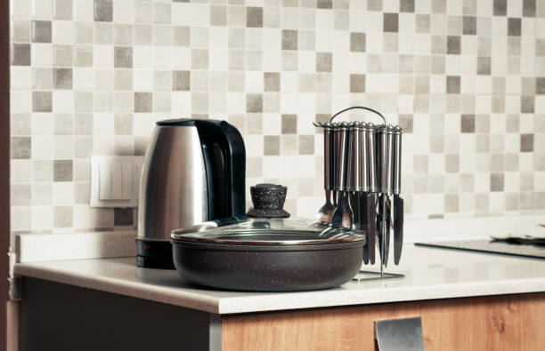 istock Close-Up Of Utensils Kitchen Counter Against Wall At Home 1148155482