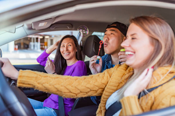 istock Cheerful friends talking during a road trip in a car. 1148157246