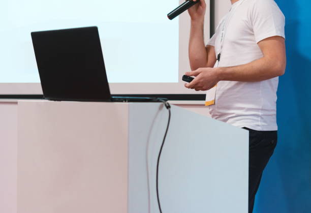 istock Midsection Of Man Speaking On Microphone While Standing Against Wall 1148158045