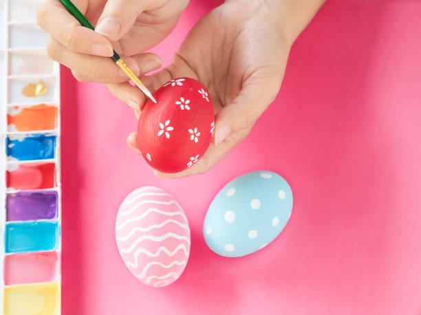 istock People painting colorful Easter eggs 1148159771