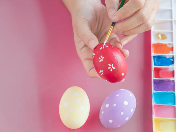 istock People painting colorful Easter eggs 1148159875
