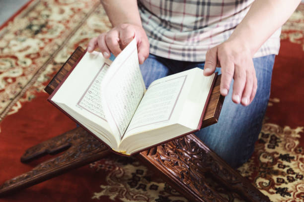 istock Midsection Of Man Reading Koran In Mosque 1148160225