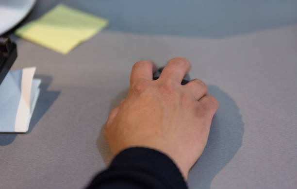 istock Cropped Hand Of Business Person Using Computer Mouse On Desk In Office 1148160242
