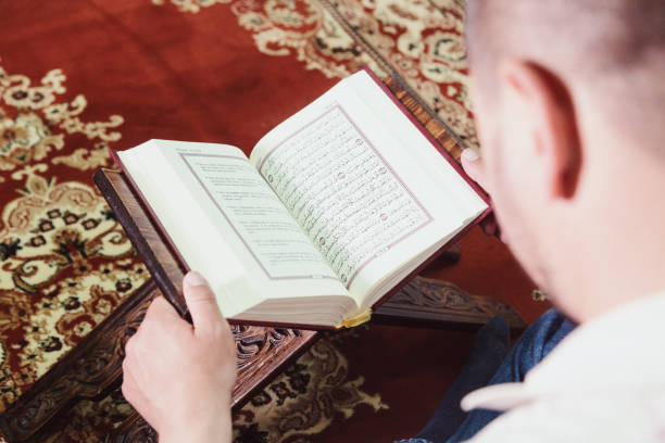 istock High Angle View Of Man Reading Koran In Mosque 1148161538