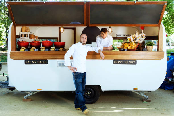 istock Handsome young chef looking at camera in a food truck. 1148161611