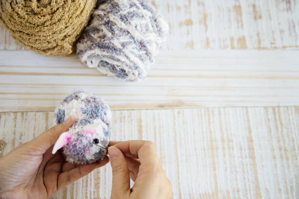 istock Woman making lovely bunny doll from yarn 1148165742
