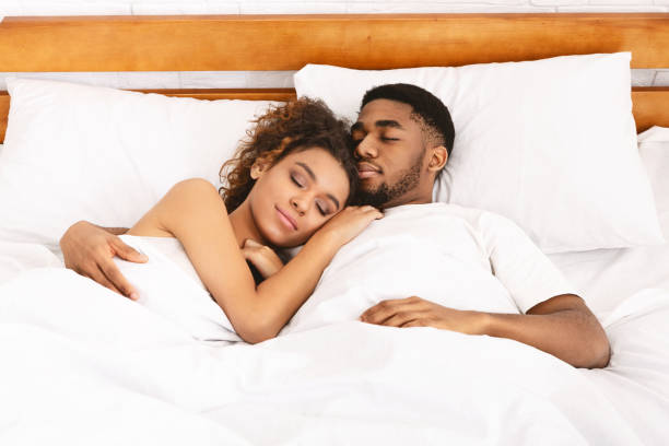 istock Loving couple sleeping in bed and hugging 1148166937