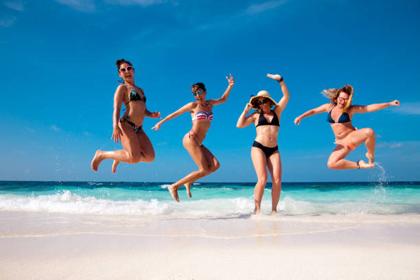 istock Friends enjoying a tropical beach vacation 1148168515