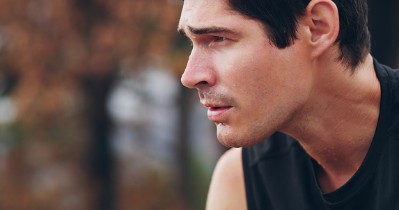 Cropped shot of a young man sweating excessively after his run