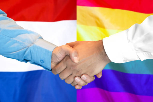 istock handshake on LGBT gay and Netherlands flag background. 1148170202