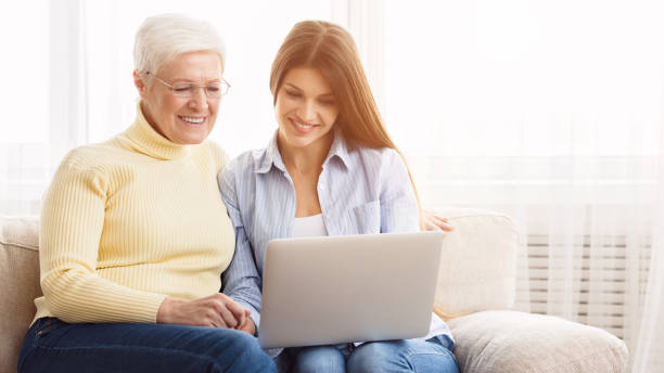 istock Daughter and mother surfing internet on laptop 1148170233