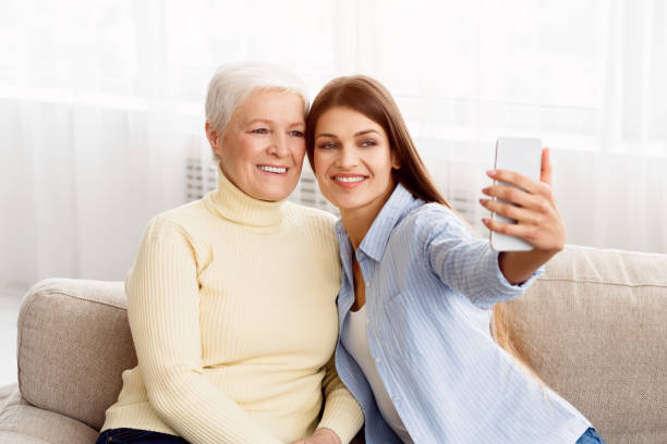 istock Happy mother and young daughter taking selfie 1148170240