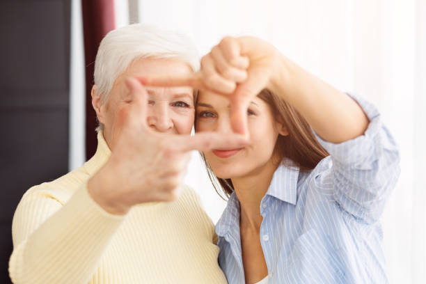 istock Happy mom and daughter making frame with fingers 1148170248
