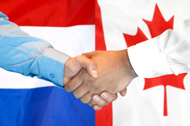 istock handshake on Canada and Netherlands flag background. 1148170460