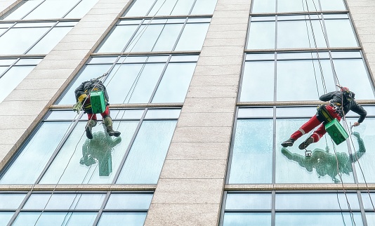 Alpinists wash windows of skyscraper in Moscow
