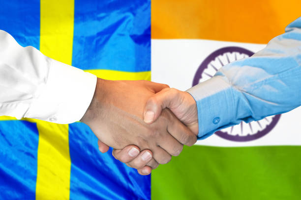istock handshake on India and Sweden flag background. 1148171247