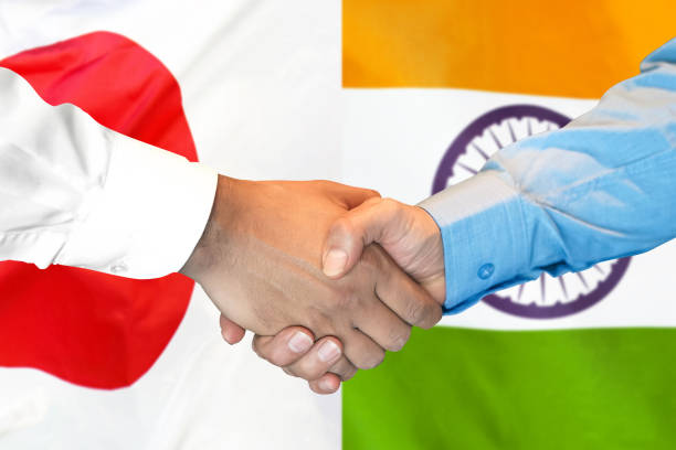 istock handshake on India and Japan flag background. 1148171316