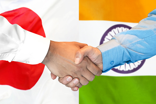 Business handshake on the background of two flags. Men handshake on the background of the India and Japan flag. Support concept