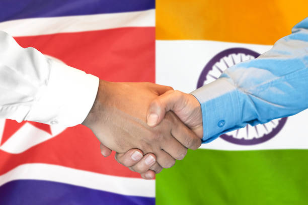 istock handshake on India and North Korea flag background. 1148171565