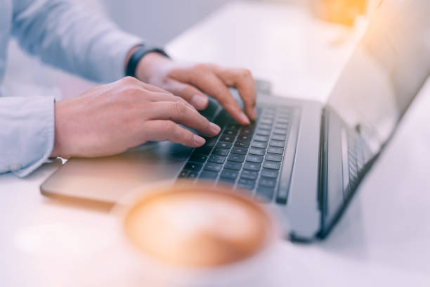 istock Hands of businessman working at cafe.Typing on laptop close-up. Man working on computer. 1148171741