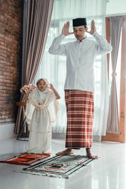 istock muslim man with her daughter praying 1148173106