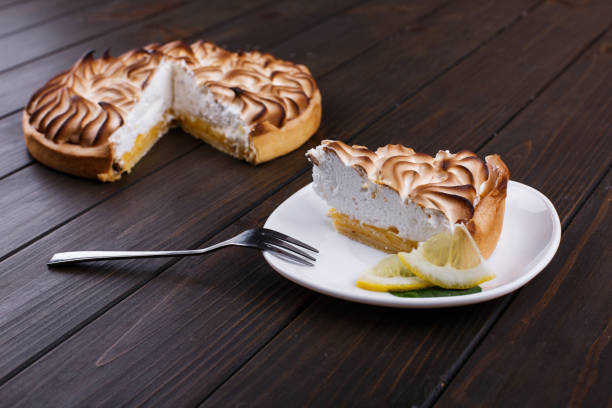 istock Piece of lemon pie with white cream served on white plate 1148175878